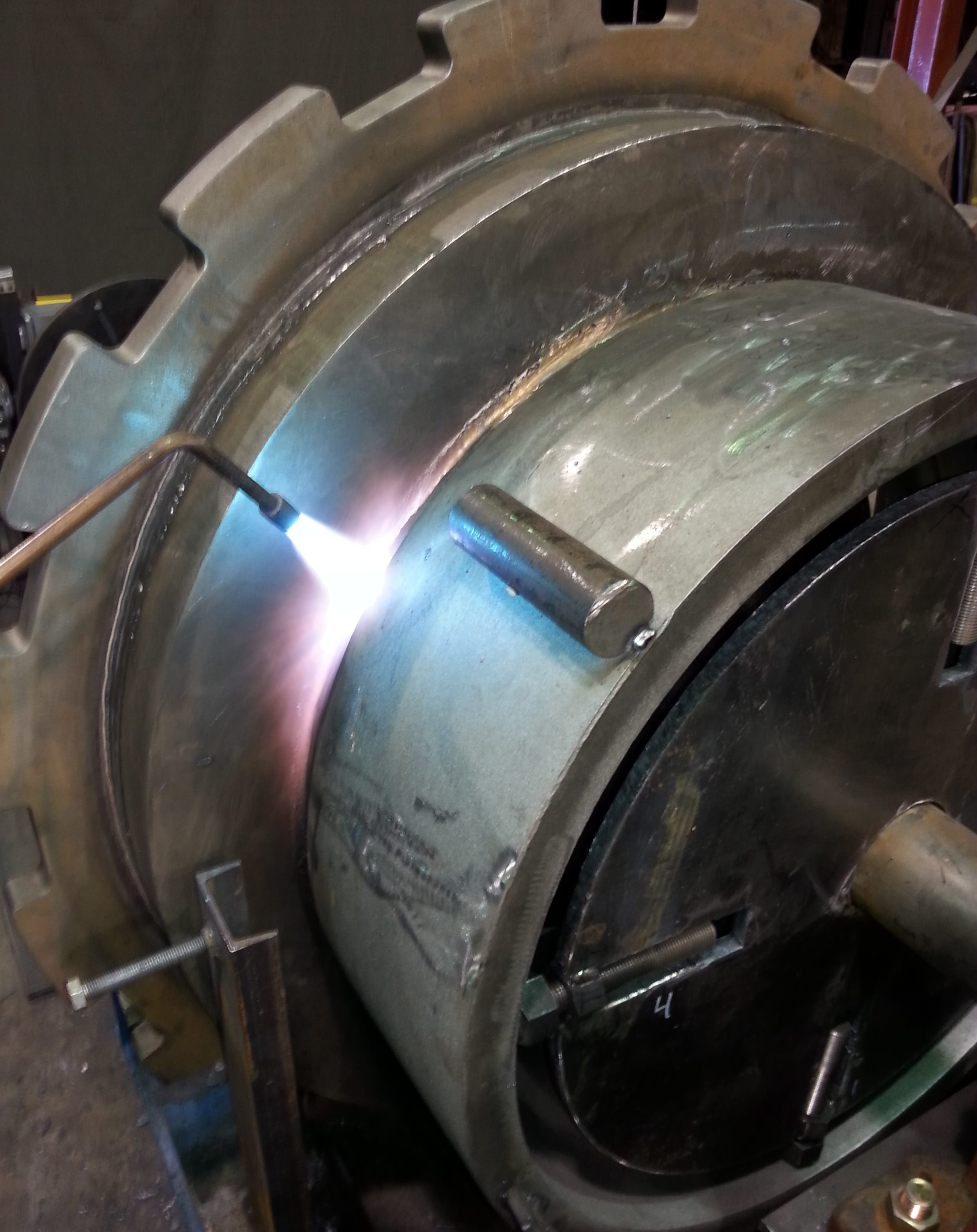 Preheating of fabricated rotating assembly for a rotary table. Preheating ensures minimal stress on material and ensures a full penetration weld